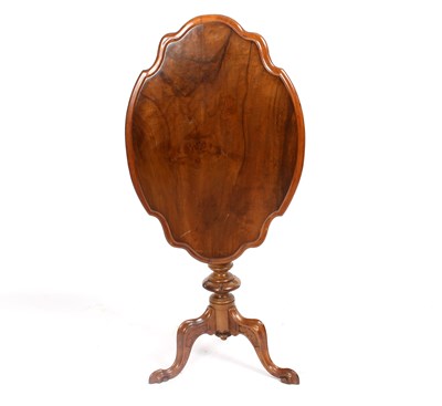 Lot 733 - A shaped oval walnut table, the top with...