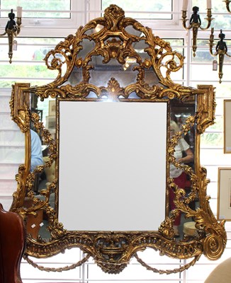 Lot 742 - A gilded wall mirror with central shell...