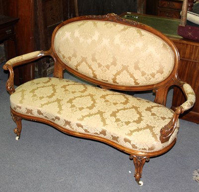 Lot 746 - A Victorian walnut settee, the oval padded...