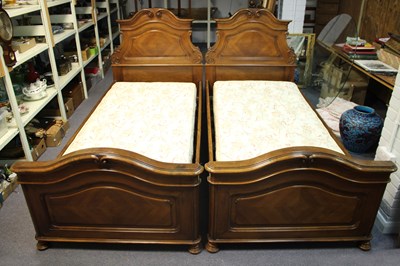 Lot 756 - A pair of French walnut bedsteads with arch...