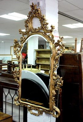 Lot 772 - A gilded wall mirror, the frame with surround...