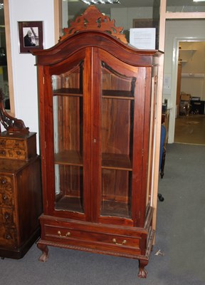 Lot 784 - An arch top display cabinet with glazed doors...