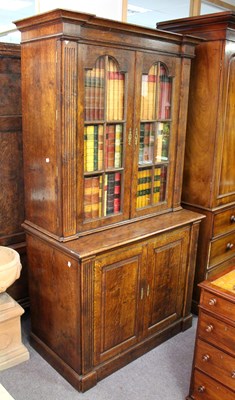 Lot 793 - An oak cupboard in two sections, the top...