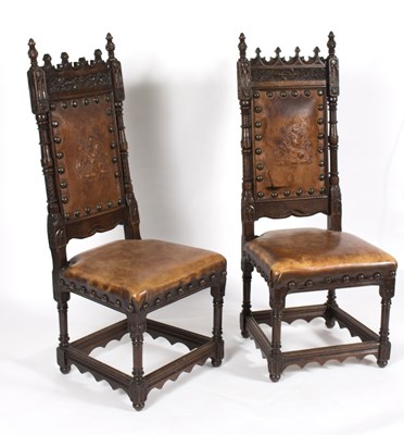 Lot 825 - A pair of Gothic revival oak hall chairs with...