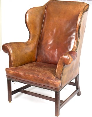 Lot 842 - A George III leather upholstered wingback...