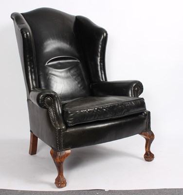 Lot 862 - An 18th Century style wing back armchair...