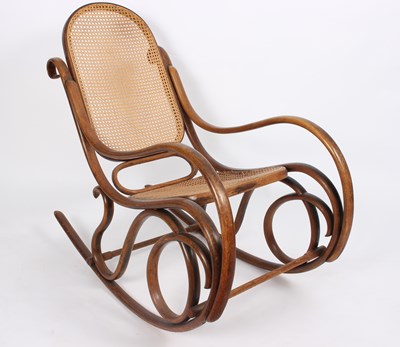 Lot 871 - A bentwood rocking chair with cane back and seat