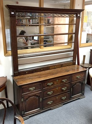 Lot 875 - A George III oak dresser with open rack above,...