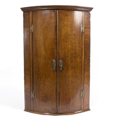 Lot 891 - An 18th Century oak bowfront corner cupboard,...