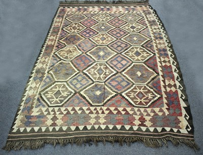 Lot 934 - A Kilim rug worked in browns, cream and blue,...