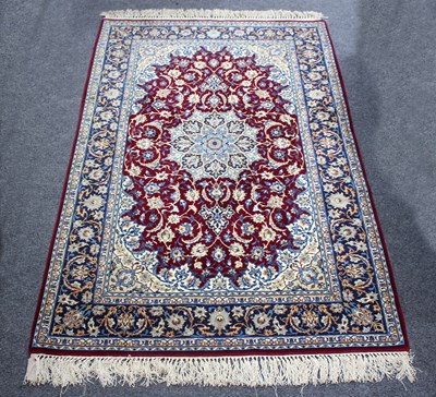 Lot 944 - A Qum rug with crimson ground geometric field...