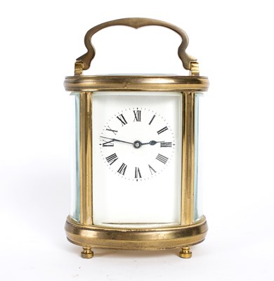 Lot 1034 - An oval gilt brass cased carriage clock, the...