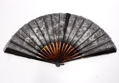 Lot 1050 - A black lace fan with tortoiseshell sticks, a...