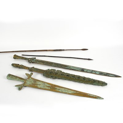 Lot 1073 - Three bronzed swords, a tribal arrow and another