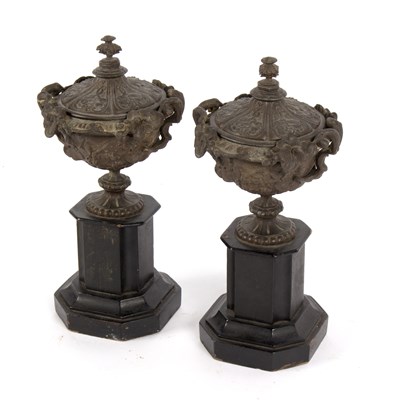 Lot 1081 - A pair of spelter urns and covers, on wooden...