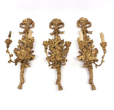 Lot 1094 - A set of three giltwood wall appliques, each...