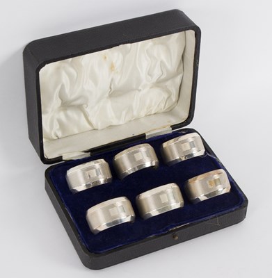 Lot 47 - A set of six silver napkin rings, GUS & L,...
