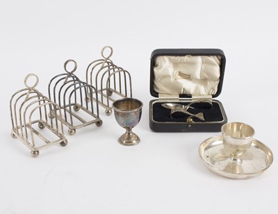 Lot 56 - Three silver toast racks, London 1956, two...