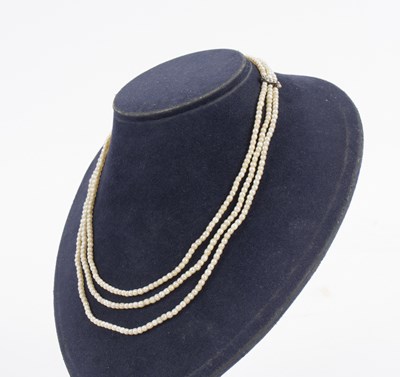 Lot 104 - A three-row seed pearl necklace, the strands...