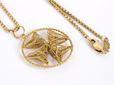 Lot 113 - A gold Maltese cross filigree pendant on an...