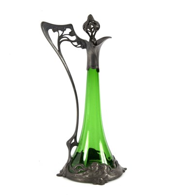 Lot 161 - An Art Nouveau green glass claret jug, with...