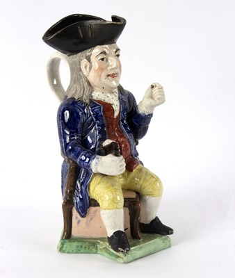 Lot 207 - A 19th Century pearlware Toby jug, The Squire,...