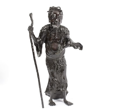 Lot 310 - A Japanese bronze figure of a man holding a...