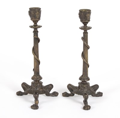 Lot 360 - A pair of bronze candlesticks, on tripod...