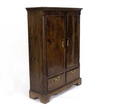 Lot 516 - A two-door oak cupboard with fluted pilasters...