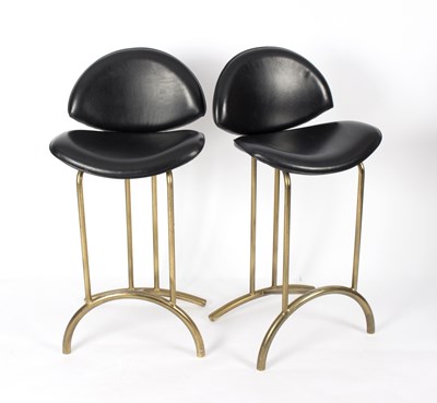 Lot 530 - A pair of black leather bar stools on gilt...