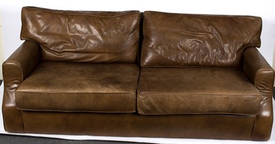 Lot 551 - A modern brown leather three seater sofa