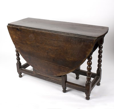 Lot 565 - A late 17th Century oak gateleg table, on ball...