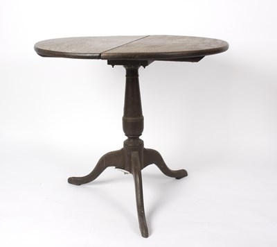 Lot 570 - An oak tripod table, 70cm high x 82cm diameter