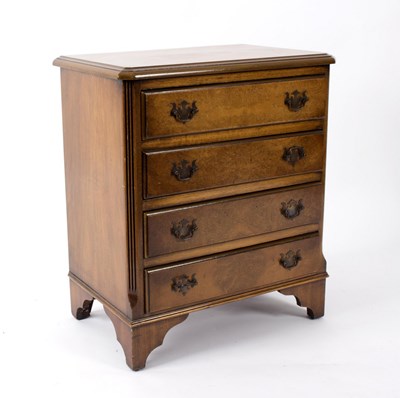 Lot 599 - A walnut chest, fitted four drawers on bracket...