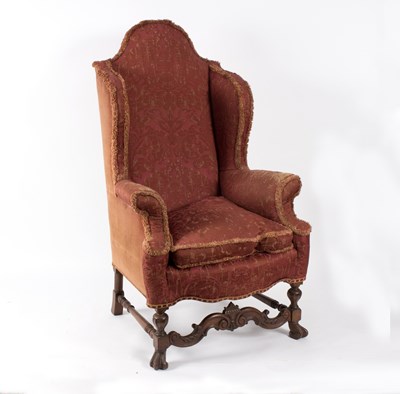 Lot 616 - A Carolean style upholstered wingback armchair...