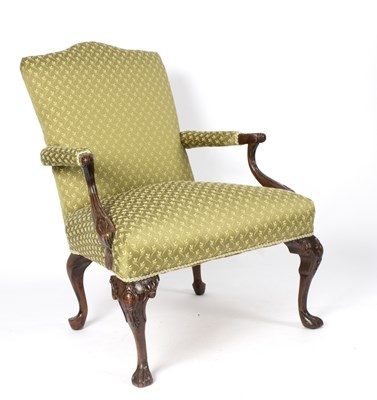 Lot 629 - An upholstered armchair on carved cabriole legs