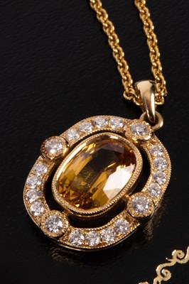 Lot 79 - An 18ct gold, diamond and yellow sapphire pendant