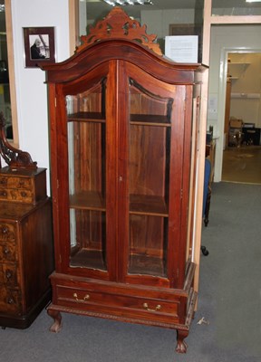 Lot 676 - An arch top display cabinet with glazed doors...