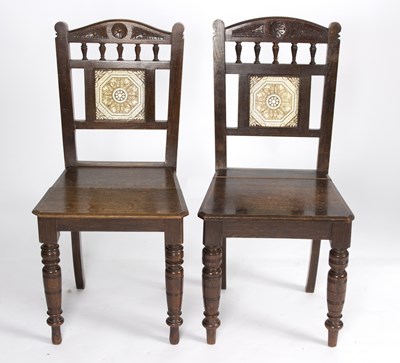 Lot 686 - A pair of aesthetic movement oak hall chairs...