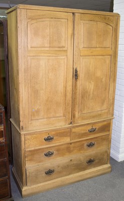 Lot 760 - An oak linen press enclosed by panelled doors...