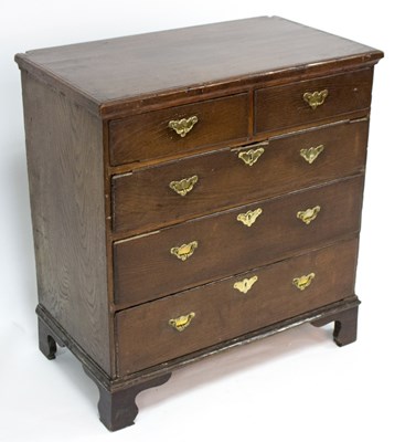 Lot 765 - A Georgian oak chest, of two short over three...