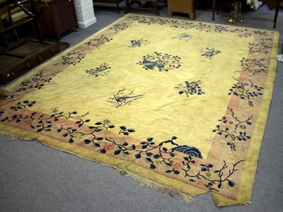 Lot 813 - A Chinese carpet decorated birds on branches...