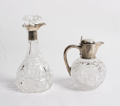 Lot 57 - A spherical cut glass claret jug, the silver...