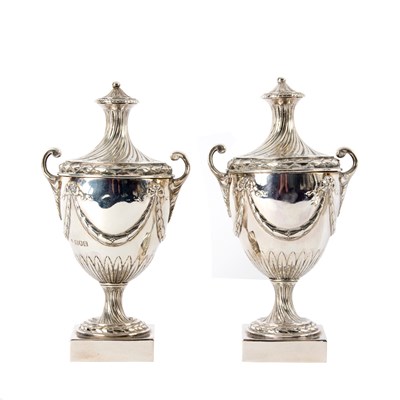 Lot 70 - A pair of Edwardian silver urns and covers,...