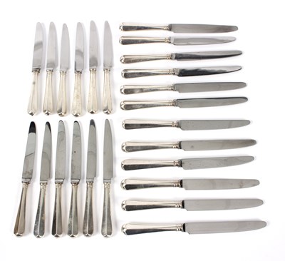 Lot 106 - A set of twelve silver handled table knives...