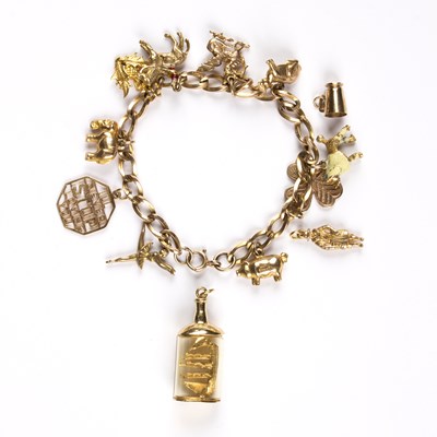 Lot 133 - A gold charm bracelet, charms to include a...