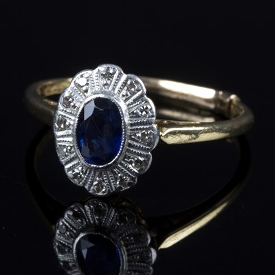 Lot 141 - A sapphire and diamond cluster ring, the oval...