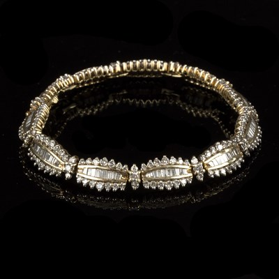 Lot 175 - A diamond bracelet of eleven oblong cluster...