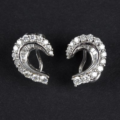 Lot 192 - A pair of diamond earrings of stylised...