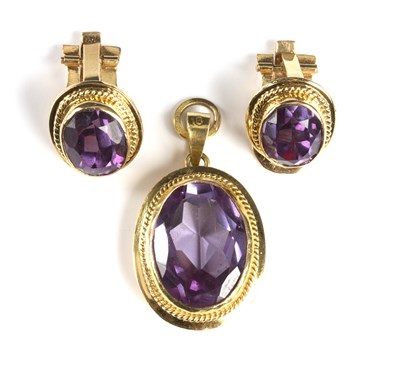 Lot 214 - A corundum pendant and matching clip earrings...